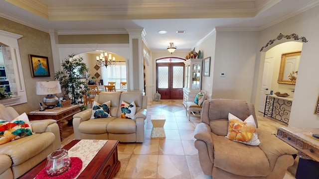 living room featuring french doors, crown molding, an inviting chandelier, light tile patterned floors, and a raised ceiling