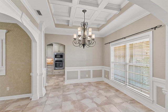 unfurnished dining area with visible vents, an inviting chandelier, wainscoting, coffered ceiling, and beamed ceiling