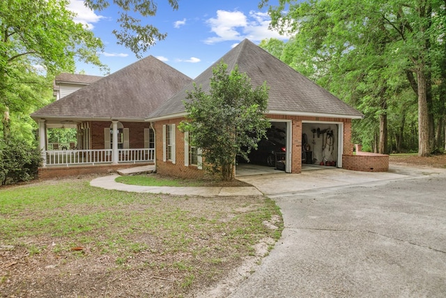 408 Shakespeare Dr, Dothan, AL 36303 - view of front of home featuring concrete driveway, a garage, brick siding, roof with shingles, and covered porch