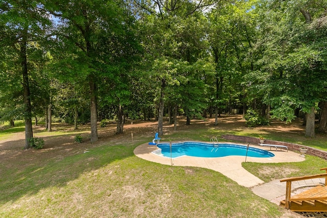 408 Shakespeare Dr, Dothan, AL 36303 - swimming pool featuring a diving board, a lawn, view of wooded area, and a patio