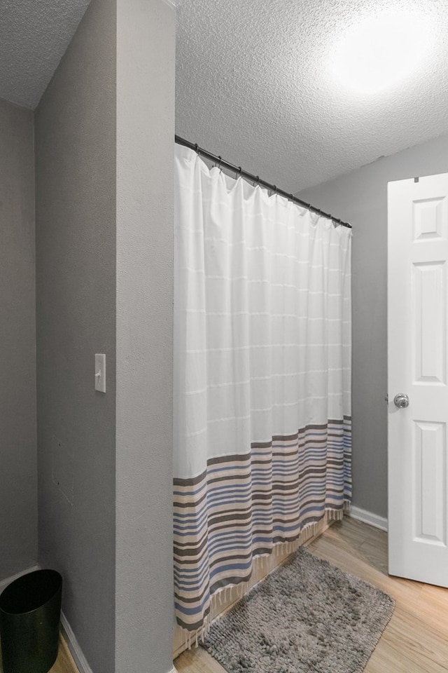 408 Shakespeare Dr, Dothan, AL 36303 - full bath with a textured ceiling, wood finished floors, and a shower with curtain