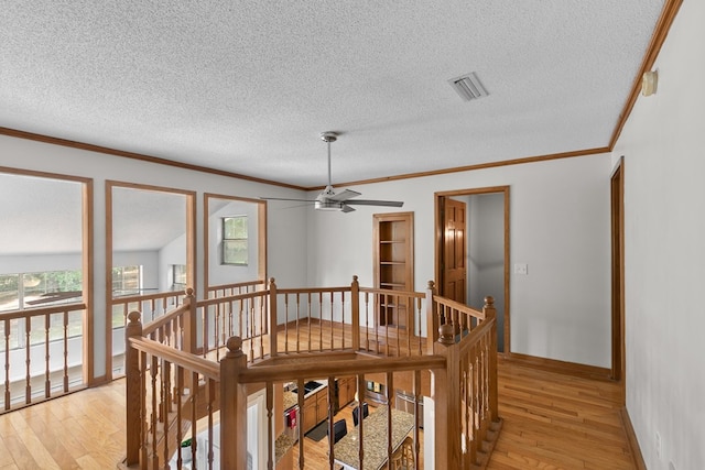 408 Shakespeare Dr, Dothan, AL 36303 - corridor with an upstairs landing, light wood finished floors, a textured ceiling, baseboards, and crown molding