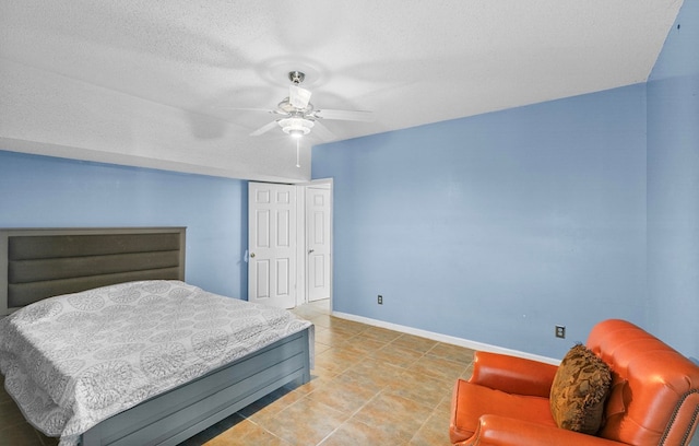408 Shakespeare Dr, Dothan, AL 36303 - bedroom featuring baseboards, ceiling fan, light tile patterned flooring, and a textured ceiling