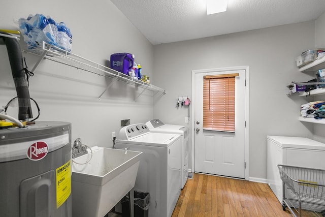 408 Shakespeare Dr, Dothan, AL 36303 - washroom with water heater, washer and clothes dryer, light wood finished floors, a textured ceiling, and baseboards