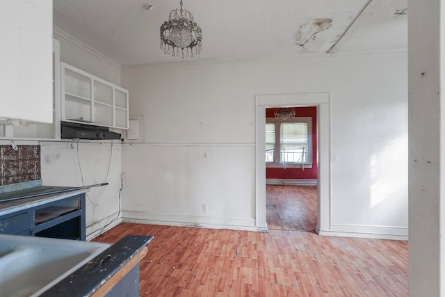 kitchen featuring crown molding and hardwood / wood-style flooring