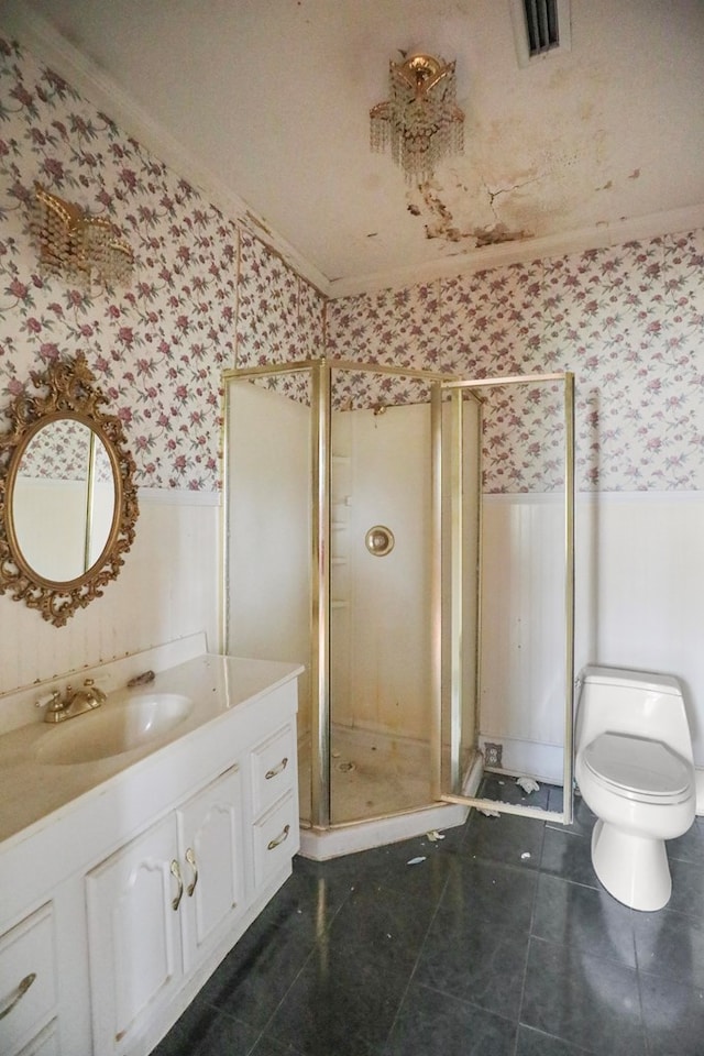 bathroom with a shower with door, tile patterned flooring, vanity, ornamental molding, and toilet