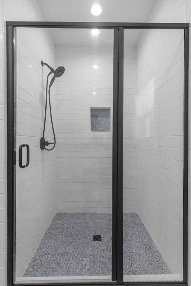 bathroom featuring a shower with door