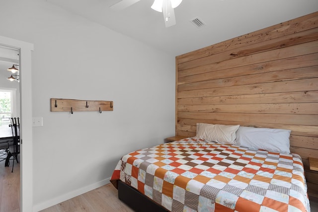 bedroom with ceiling fan and light hardwood / wood-style floors