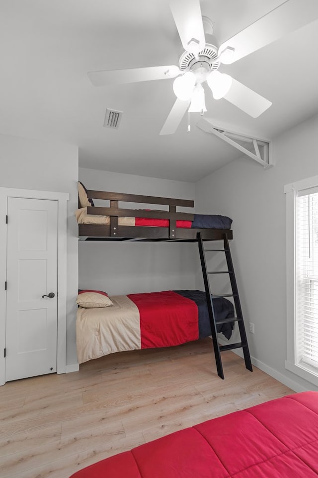 bedroom with ceiling fan and light hardwood / wood-style flooring