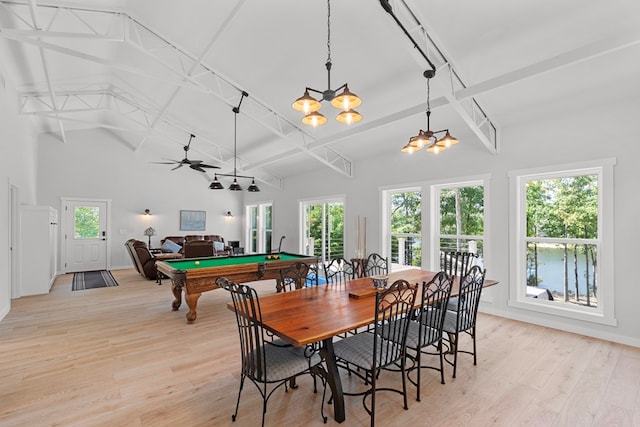 dining room featuring lofted ceiling with beams, light hardwood / wood-style flooring, a wealth of natural light, and billiards