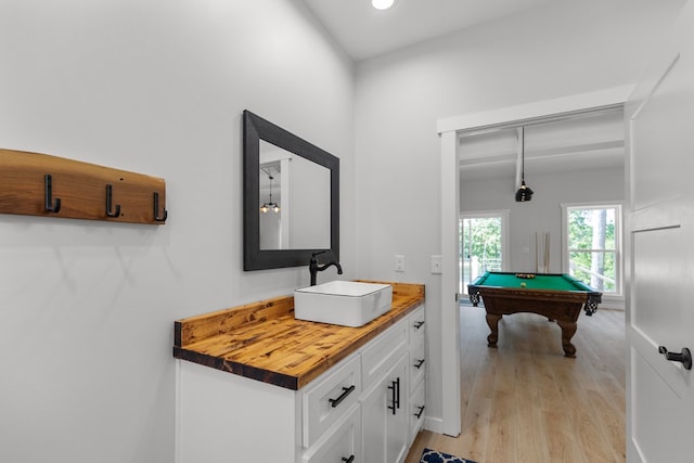 bathroom featuring vanity, wood-type flooring, and billiards