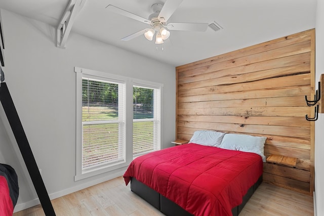 bedroom with multiple windows, ceiling fan, and light wood-type flooring