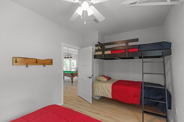 bedroom with ceiling fan, wood-type flooring, vaulted ceiling, and billiards