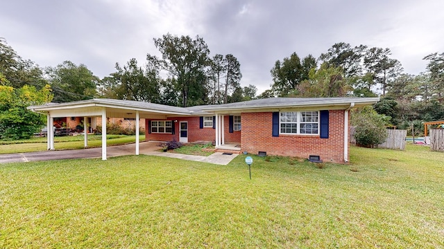 ranch-style house with a front yard and a carport