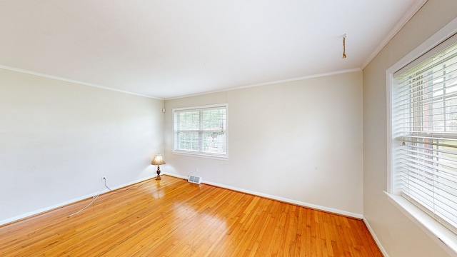 unfurnished room with hardwood / wood-style floors and ornamental molding