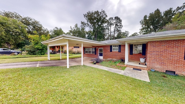 rear view of house featuring a yard and a carport