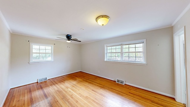 spare room with hardwood / wood-style floors, ceiling fan, and ornamental molding