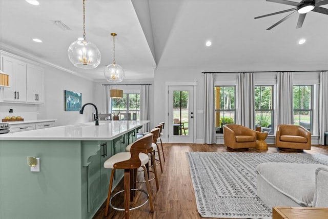 246 Suggs Rd, Dothan, AL 36345 - kitchen featuring open floor plan, light countertops, white cabinetry, green cabinets, and recessed lighting