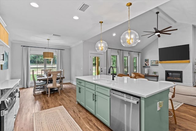 246 Suggs Rd, Dothan, AL 36345 - kitchen featuring green cabinets, appliances with stainless steel finishes, a glass covered fireplace, light countertops, and recessed lighting