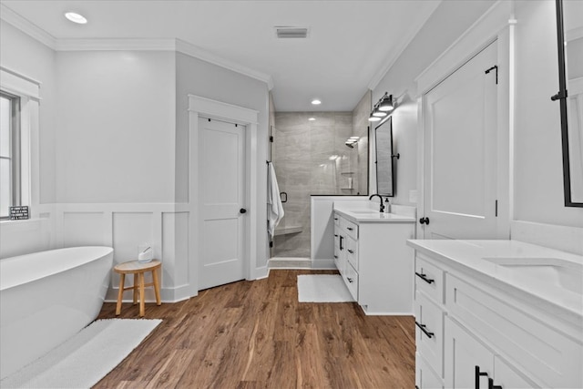 246 Suggs Rd, Dothan, AL 36345 - full bathroom with a shower stall, two vanities, a soaking tub, ornamental molding, and wood finished floors