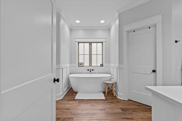 246 Suggs Rd, Dothan, AL 36345 - bathroom with ornamental molding, a freestanding bath, a wainscoted wall, wood finished floors, and recessed lighting