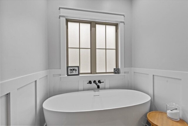246 Suggs Rd, Dothan, AL 36345 - bathroom featuring a decorative wall, wainscoting, and a freestanding tub