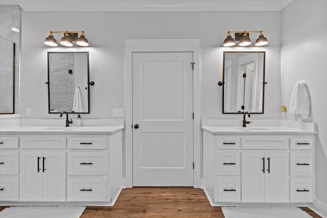 246 Suggs Rd, Dothan, AL 36345 - bathroom featuring wood finished floors, two vanities, and tiled shower