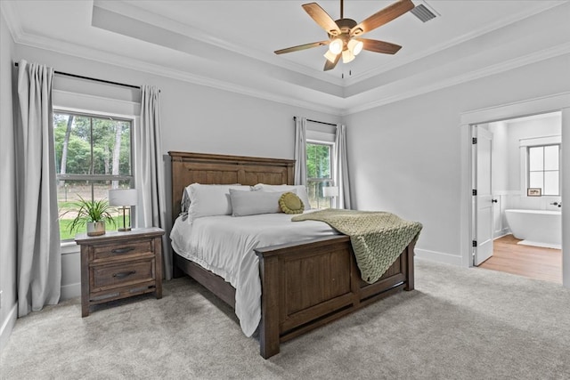 246 Suggs Rd, Dothan, AL 36345 - bedroom with a tray ceiling, light carpet, multiple windows, ornamental molding, and ensuite bathroom