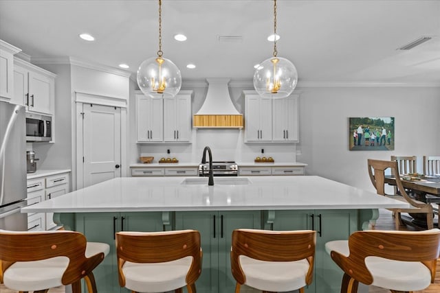 246 Suggs Rd, Dothan, AL 36345 - kitchen with premium range hood, stainless steel appliances, a kitchen bar, light countertops, and ornamental molding