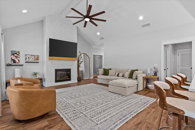 246 Suggs Rd, Dothan, AL 36345 - living area with ceiling fan, wood finished floors, a glass covered fireplace, high vaulted ceiling, and beamed ceiling