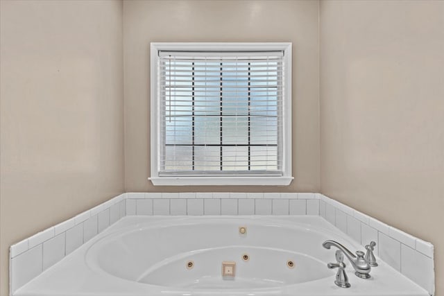 bathroom featuring a tub and a wealth of natural light