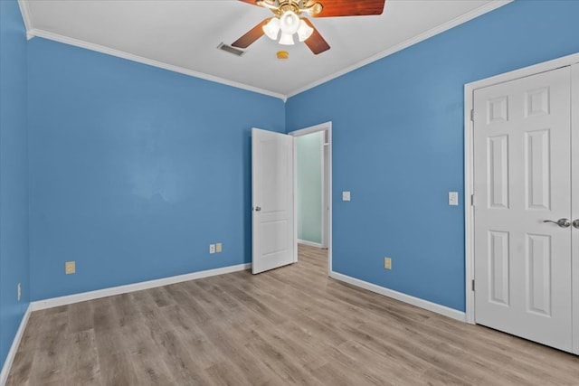 unfurnished bedroom featuring ceiling fan, crown molding, and light hardwood / wood-style flooring