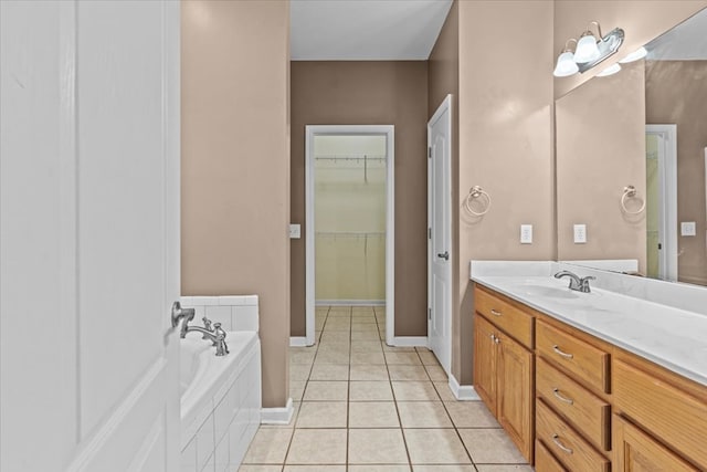 bathroom with vanity, tiled bath, and tile patterned floors