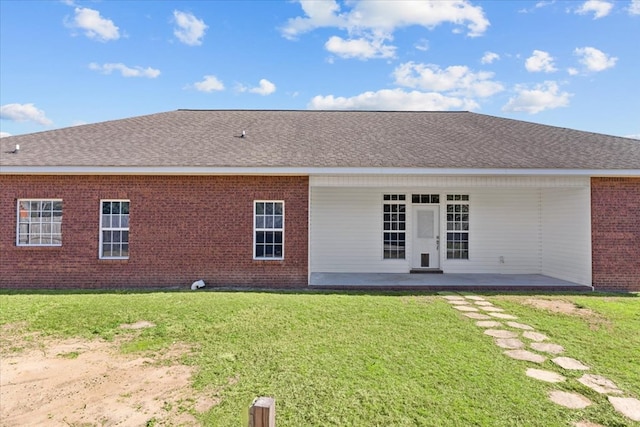 back of house with a yard and a patio area