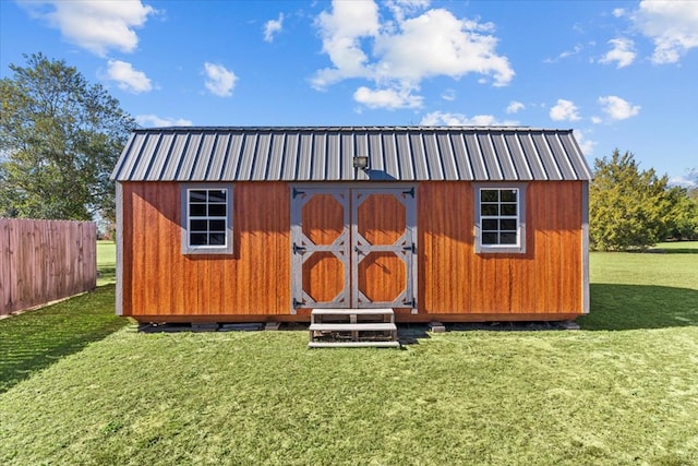 view of outdoor structure featuring a lawn