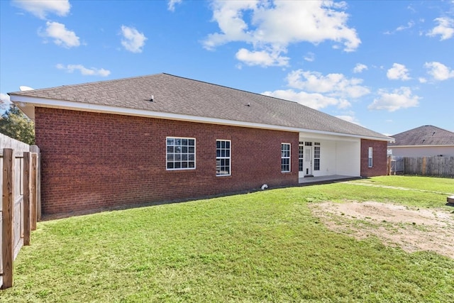 rear view of property featuring a yard