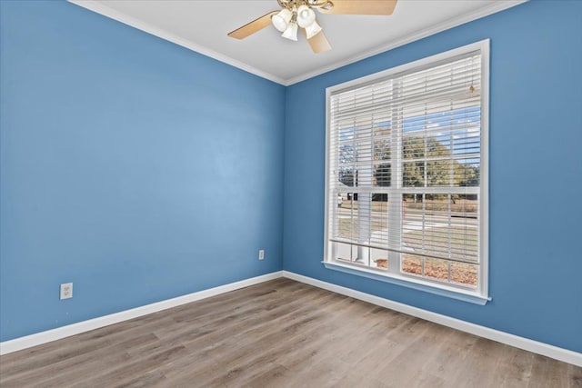 spare room featuring ceiling fan, crown molding, and wood-type flooring