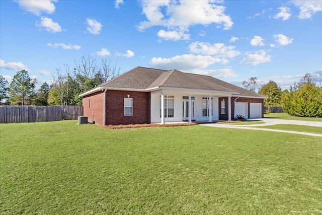 single story home with a garage, covered porch, and a front lawn