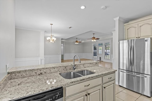 kitchen with stainless steel appliances, light tile patterned floors, ceiling fan, sink, and cream cabinets