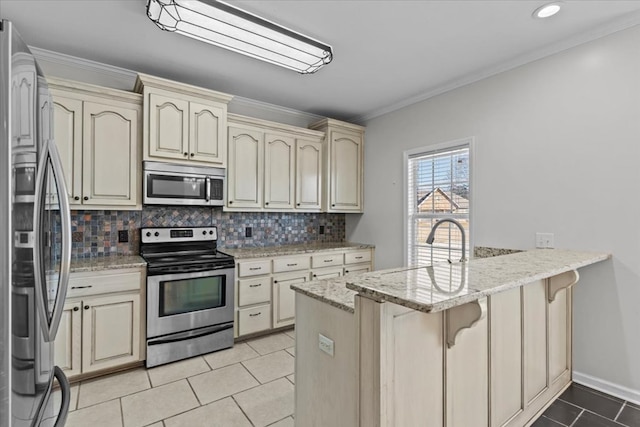 kitchen featuring light stone counters, kitchen peninsula, appliances with stainless steel finishes, and backsplash