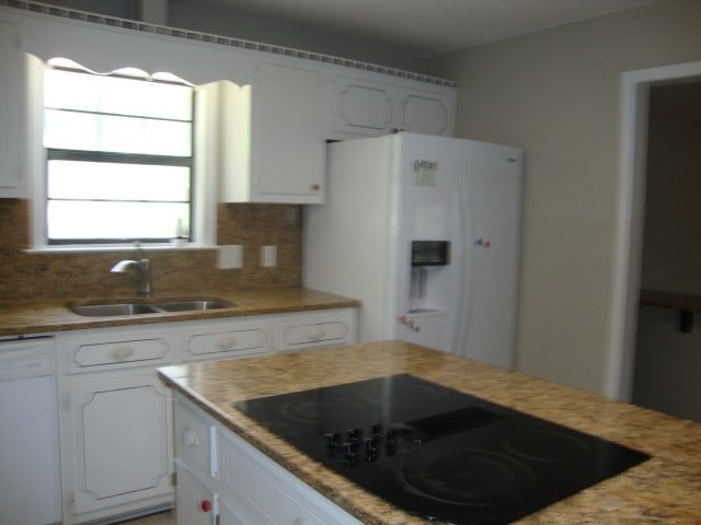 801 Early Walden Rd, Headland, AL 36345 - kitchen featuring white appliances, a sink, white cabinets, and decorative backsplash