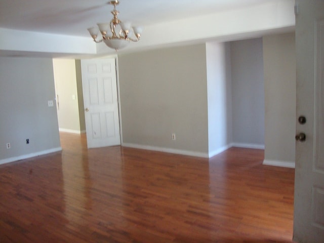 801 Early Walden Rd, Headland, AL 36345 - spare room featuring a chandelier, wood finished floors, and baseboards