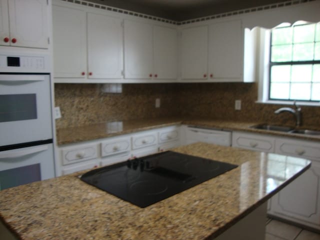 801 Early Walden Rd, Headland, AL 36345 - kitchen with white appliances, a sink, a center island, and white cabinetry