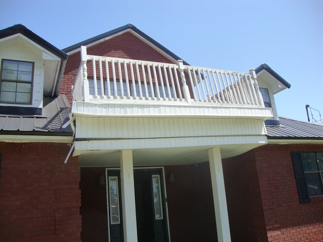 801 Early Walden Rd, Headland, AL 36345 - view of home's exterior with a balcony, brick siding, and metal roof