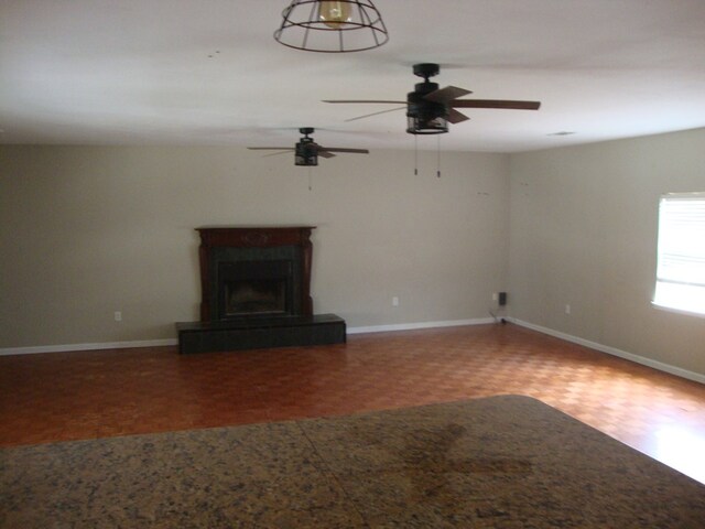 801 Early Walden Rd, Headland, AL 36345 - unfurnished living room with a ceiling fan, baseboards, wood finished floors, and a fireplace with raised hearth