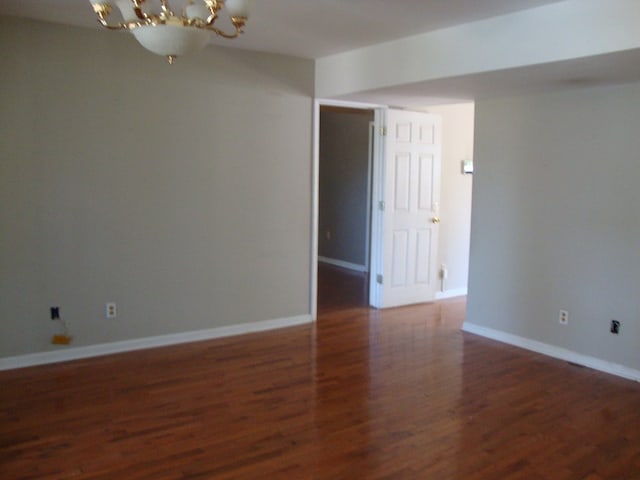 801 Early Walden Rd, Headland, AL 36345 - spare room featuring a chandelier, wood finished floors, and baseboards