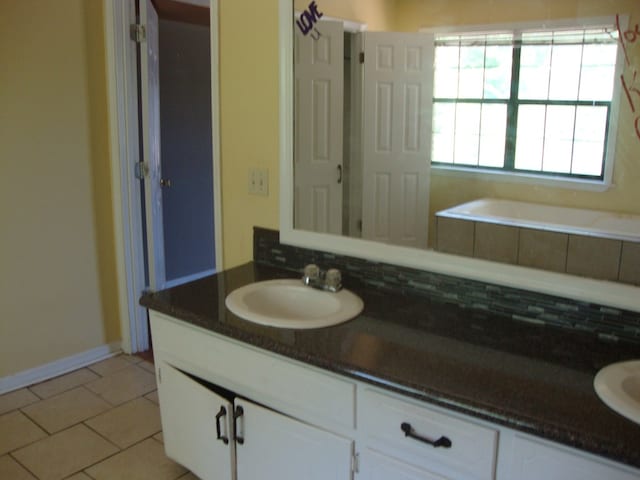 801 Early Walden Rd, Headland, AL 36345 - bathroom with backsplash, vanity, and tile patterned flooring