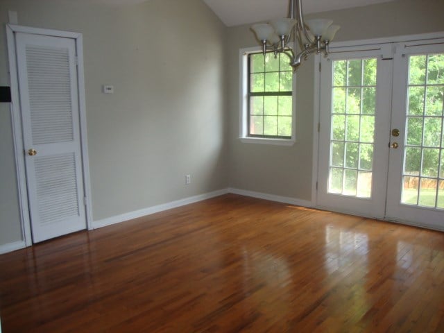 801 Early Walden Rd, Headland, AL 36345 - unfurnished dining area with a chandelier, wood finished floors, and baseboards