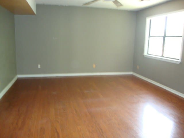 801 Early Walden Rd, Headland, AL 36345 - empty room featuring wood finished floors, ceiling fan, and baseboards