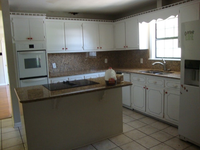 801 Early Walden Rd, Headland, AL 36345 - kitchen with white appliances, a sink, light tile patterned flooring, and tasteful backsplash
